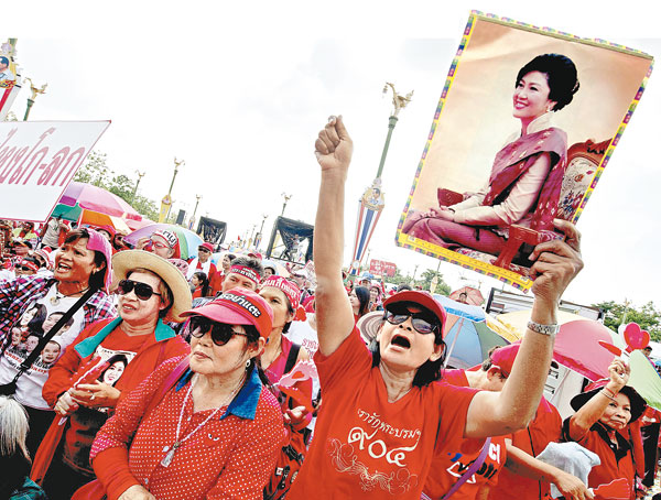 紅衫軍在曼谷城郊集結，高舉英祿的肖像聲援她。