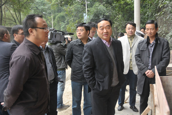 Lei Zhengfu, center, secretary of a district Communist Party committee in Chongqing, and other officials in November. Mr. Lei lost his job over a video of him having sex with a young woman.
